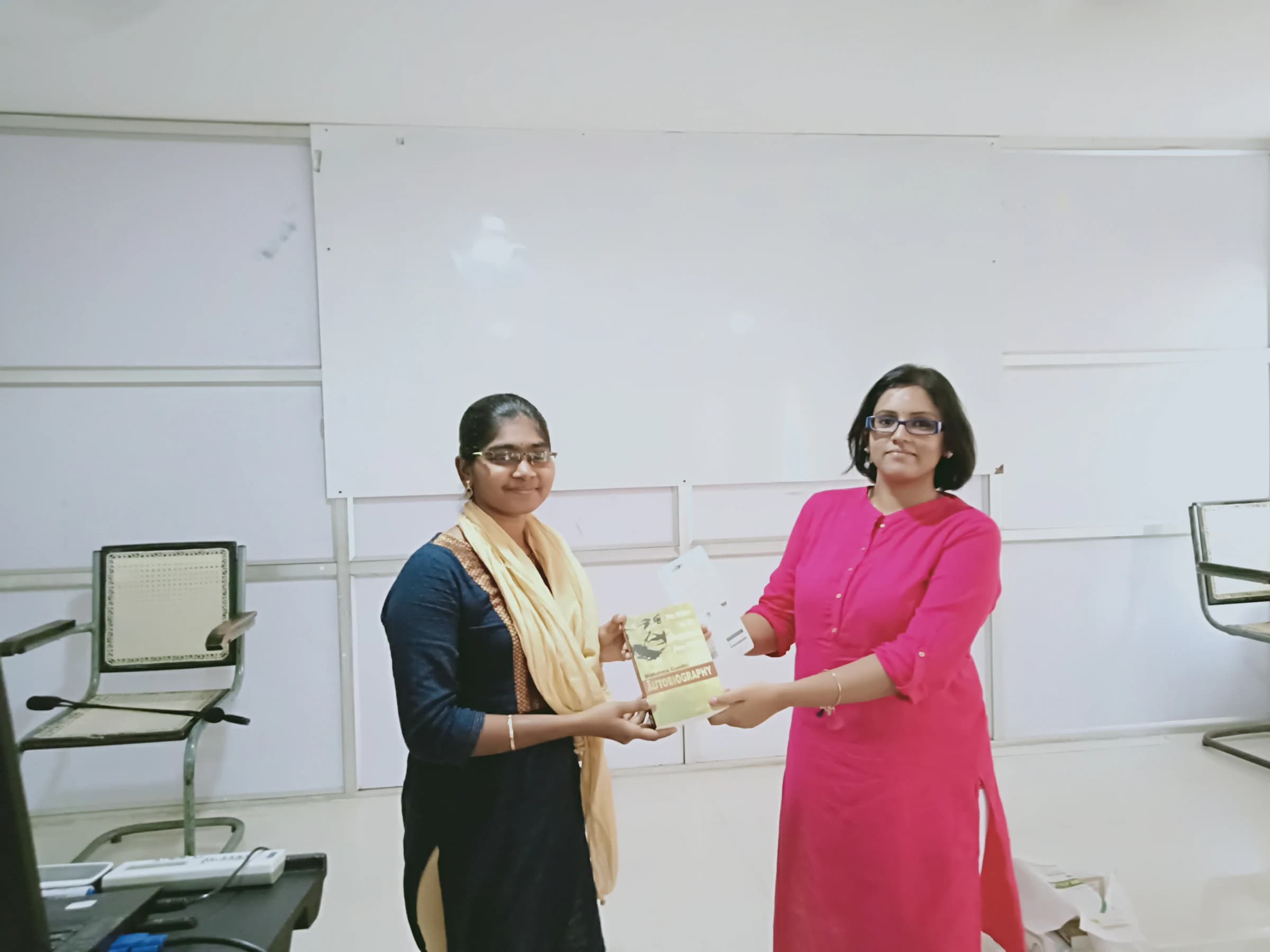 Priya receiving a certificate in a classroom