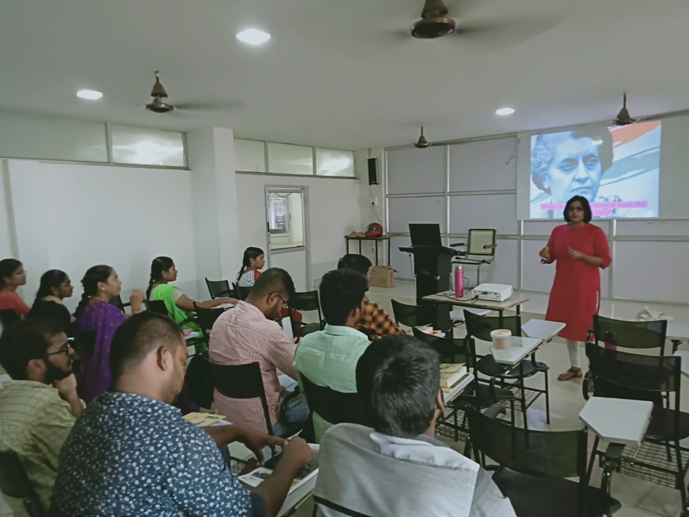Priya speaking to an audience in a classroom